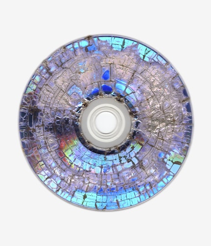 This artwork is part of the series “Free Software”, a body of work inspired by the YouTube genre of putting unusual things in a microwave. One of the most intriguing items is a CD. When microwaved, CDs create a little lightning storm inside the microwave. After being zapped the disk emerges with a unique and mesmeric fractal pattern burned into it. 

For the NFT, Kneale uses a high resolution scanner to make 4800 dpi scans of the burned disks, translating the intricate detail of the CD, and creating rainbow effects in the reflective surface.