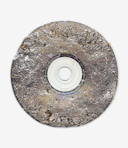 This artwork is part of the series “Free Software”, a body of work inspired by the YouTube genre of putting unusual things in a microwave. One of the most intriguing items is a CD. When microwaved, CDs create a little lightning storm inside the microwave. After being zapped the disk emerges with a unique and mesmeric fractal pattern burned into it. 

For the NFT, Kneale uses a high resolution scanner to make 4800 dpi scans of the burned disks, translating the intricate detail of the CD, and creating rainbow effects in the reflective surface.