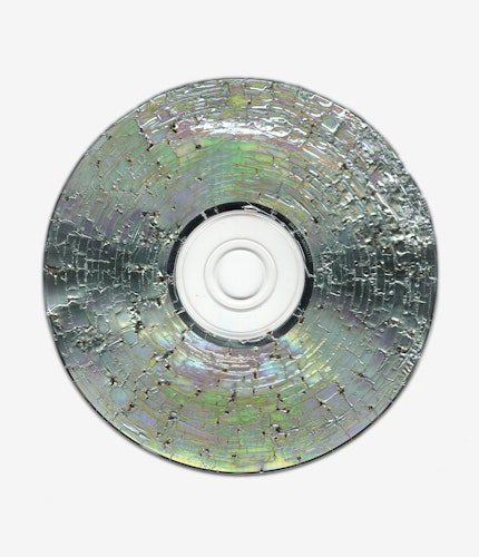This artwork is part of the series “Free Software”, a body of work inspired by the YouTube genre of putting unusual things in a microwave. One of the most intriguing items is a CD. When microwaved, CDs create a little lightning storm inside the microwave. After being zapped the disk emerges with a unique and mesmeric fractal pattern burned into it. 

For the NFT, Kneale uses a high resolution scanner to make 4800 dpi scans of the burned disks, translating the intricate detail of the CD, and creating rainbow effects in the reflective surface.