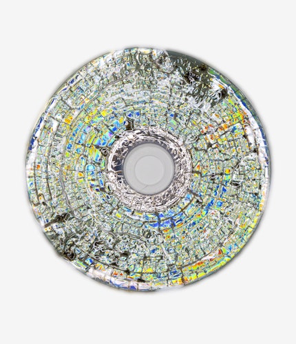 This artwork is part of the series “Free Software”, a body of work inspired by the YouTube genre of putting unusual things in a microwave. One of the most intriguing items is a CD. When microwaved, CDs create a little lightning storm inside the microwave. After being zapped the disk emerges with a unique and mesmeric fractal pattern burned into it. 

For the NFT, Kneale uses a high resolution scanner to make 4800 dpi scans of the burned disks, translating the intricate detail of the CD, and creating rainbow effects in the reflective surface.